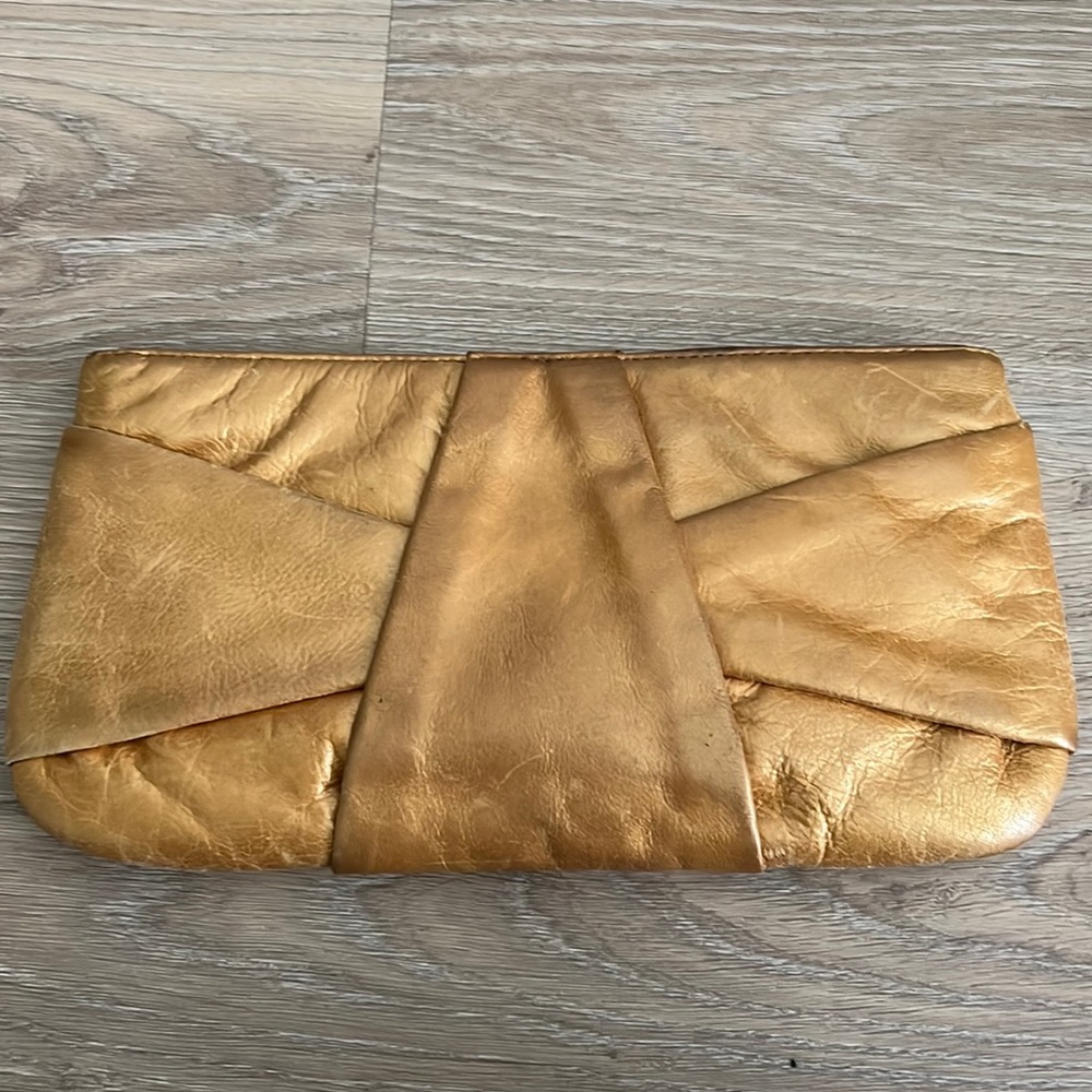 Leather clutch with removable strap to create a handbag